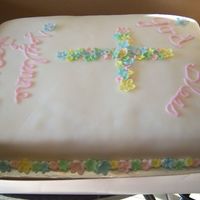 Jaylenne's 1St Communion White cake filled with cheesecake. Covered with fondant,flowers are also fondant. Writing is royal icing.