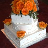 Fall Wedding 10" square, 8" round, 6" square. Fresh roses, buttercream. Top assembled in a "blob" of fondant to hold it. The...