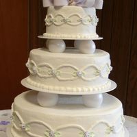 Lavender Bow Wedding Cake I still need to practice my bows and the arches on the sides of the cake. Everyone was very happy with it, especially after they tasted it...