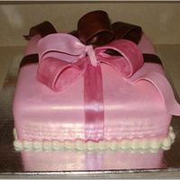 Pink And Brown Present Almond butter cake, almond buttercream underneath fondant, bow is gumpaste, pearl border is fondant, dark pink ribbon is painted with...