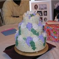 Wisteria, Lilly Of The Valley And Roses This was the 3rd cake I ever made. Its a non-crusting cream cheese icing with fondant lilly of the valley and roses.