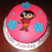 Dora Cake buttercream cake with fondant flowers and painted dora on sugarpaste