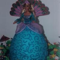 Peacock Barbie My niece's birthday cake. White cake with buttercream frosting. I used the wonder mold pan for the dress part with an 8" layer...