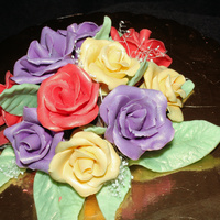 Chocolate Rose Cake Topper Roses and leaves are made out of modeling chocolate. Dusted everything with luster dust.
