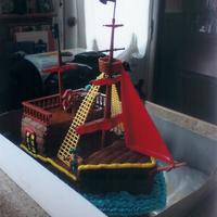 Pirate Ship Vanilla cake with buttercream icing. I used a pirate ship kit for the plastics, first time using that type of kit and it worked well....