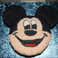 Mickey Mouse Not my best work but a lot better than my first. The head is a 9" yellow cake and the ears are 6" cookies and cream cakes.