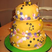 Queen Bee Cake made for me by my sister!!! How sweet was that?!?! Bee hive with bees and flower accents. Covered with fondant, RI and fondant accents...