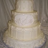 100_0591.jpg Ivory Wedding Cake with fondant plaque and fondant accents.
