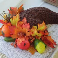 Cornucopia This is a Chocolate Cake, covered with Chocolate Frosting. The Veggies are made out of Fondant.