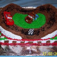 Racetrack Cake With Cars Characters With a lot of inspiration from the cakes at CC.com-For my son's 4th birthday. Baked a 9x13 sheet cake and two 9 inch cakes. My husband...