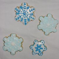 Snowflake Cookies No fail sugar cookies with royal icing and a sprinkle of disco dust.