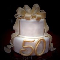 50Th Golden Anniversary Cake made this for an aunt and uncle's golden anniversary. my first attempt at this type of bow (i forget what it's called...lol)....