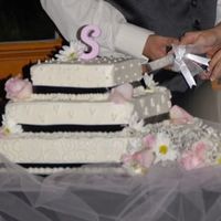 My First Wedding Cake This is my first cake - man was I nervous - All three tiers are deep chocolate with cream cheese filling and vanilla BC icing. Decorated...