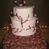 First Wedding Cake Red velvet cake with vanilla buttercream and fondant. Gumpaste cherryblossoms and tootsie roll covered wires for branches.