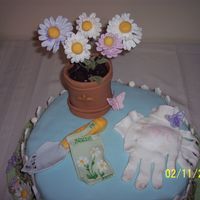Gardener's Birthday This was designed for my Aunt Nita's 50th birthday. It was my third fondant/gp cake. I used the large 15" petal pan and took the...
