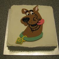 Birthday Cake Buttercake covered in buttercream. Picture make from fondant, features drawn with black gel.