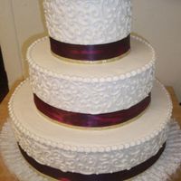 Burgandy And Gold Wedding Cake done in Ivory butter cream with ribbon