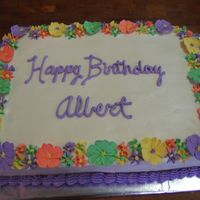 Lei Cake This is made to represent a lei for a luau party. The cake is yellow w/BC icing. Flowers are all royal.