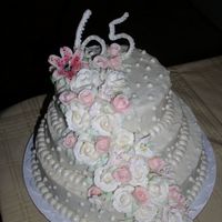 65Th Anniversary Cake 65th anniversary cake for my grandparents...roses and lilies are royal icing. Stargazer lily on top is gum paste, as well as some...