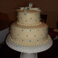 Wedding Cake This is WASC cake with pineapple filling and a pina colada icing topped with fondant. The calla lilies are also made of fondant