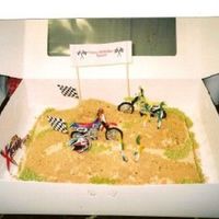 Dirt Bikes 1/2 sheet with ramps covered in buttercream, brown sugar for dirt