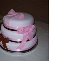 Pink And Brown Wedding 3 stacked round tiers of almond, chocolate and yellow cake with strawberry filling. Ribbon adornment and fondant bows.
