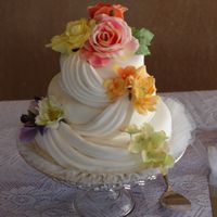 Swags And Silk Fondant cake with fondant swags, silk flowers, buttercreme and traditional wedding cake underneath. Made it for my mother-in-law. She loved...