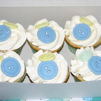 Cute As A Button White sponge cake, layered and filled with french vanilla buttercream with a hint of raspberry flavouring. Buttons are fondant.