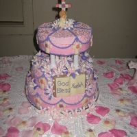 Christening For Kaelah Royal icing lillies with chocolat bible and cross. Buttercream strawberry, vanilla and chocolate cake.