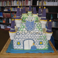 Olv Castle Everthing seen is edible. All buttercream icing. Vanilla, strawberru anc chocolate cake. Ice cream cone tops of turrets. Chocolate shield....
