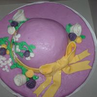 Easter Bonnet First time i used CBC. All the detail work is fondant. Bottom of cake is a huge sugar cookie. Very simple