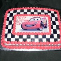Lightning Mcqueen Iced in buttercream...Then I printed out black and white checks I created in an excel worksheet on an icing sheet and pieced it together...