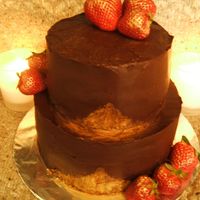 Chocolat Mint Chocolate Ganache covering chocolate cake with peppermint frosting between the layers. Gold sparkle dust has been brushed on to the...