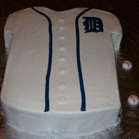 Detroit Tigers Jersey 11x15 chocolate cake carved, then iced in buttercream frosting with fondant accents. Thanks for the idea swtness.