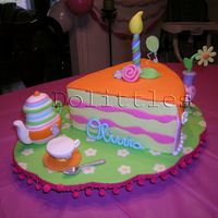 Olivia's Birthday Cake The base is a oval scalloped board covered in fondant with white inlaid flowers and yellow centers.The teapot is carved out of styrofoam...