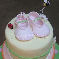 Rachel's Baby Shower Cake This is a closer look at the shoes . There is a bracelet in the first shoe . I wrote baby on the 4 beads in the middle and tied it together...