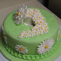 Daisies My final cake for the Wilton Fondant and Gumpaste class. The board and cake are covered in MMF and the daisies and gift box are made of...