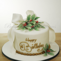 Bow & Holly Small birthday cake with gumpaste bow and holly. Writing and border is luster dust painted royal icing.Thanks for looking!