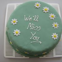 118345573582699.jpg 3 layer golden lemon pound cake filled with lemon buttercream and covered with fondant. The daises are gumpaste with royal icing centres...