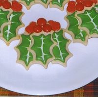 Holly Sugar cookies with royal icing and red M&Ms for the "berries" in the cookie in front.