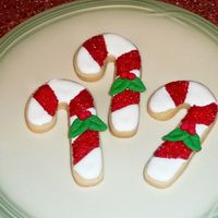 Candy Canes Rich Rolled Sugar Cookies with royal icing; both recipes from the Joy of Cooking. Decorated with red sanding sugar and hand-molded fondant...