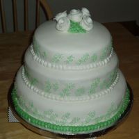 Fondant Wedding Cake Cake for my best friend. White fondant with small green accents. Cake is white with Bavarian Cream filling.