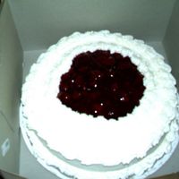 Daughter's Best Friend's Mom's Birthday My first paid cake cheesecake with rasberry filling and topping with whipped cream icing.