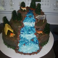 Waterfall Thanks to all the neat ideas on here, this is my concoction of a waterfall cake. Marble cake with BC icing, graham cracker tent, cone trees...
