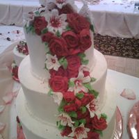 First Wedding Cake this was a 12,9,6 wasc with sugar shacks bc with royal icing lilies and roses cascading down.she also ordered a 9,6 and a single 6[they...