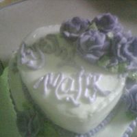 Stacked Hearts vanilla cake with bc and purple roses,made as a surprise for a freind who always used to joke that i should make her a cake.it was also my...