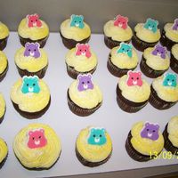 Care Bears here are some chocolate cup cakes with butter cream icing and candie care bear heads.