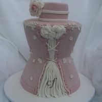 Corset Wedding Cake Made with 5 cake dummies and sculpted. This was a practice cake i made for a bridal show. If i did it again i would sculpt it more in the...