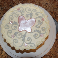 Butterfly With Scrolls Pumpkin chocolate chip spice cake with cream cheese frosting. Butterfly and flowers are fondant brushed with luster dust.