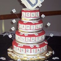 A "scrabble" Wedding Marble cake with chocolate mousse filling and buttercream. Covered in MMF. Decorations done in gumpaste/ fondant mix.